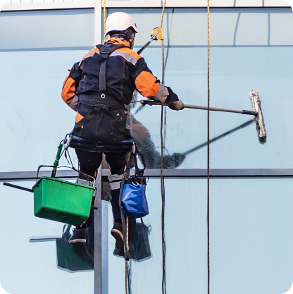worker-cleaning-windows-office-high-rise-building
